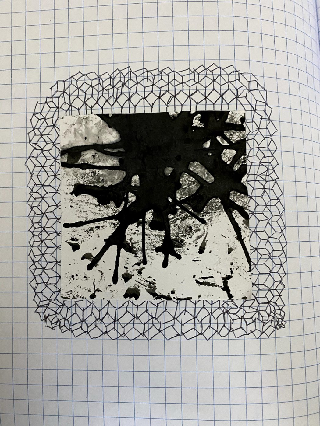 Notebook page with a square of black ink splatter framed by a border of hand-drawn cube lattice.